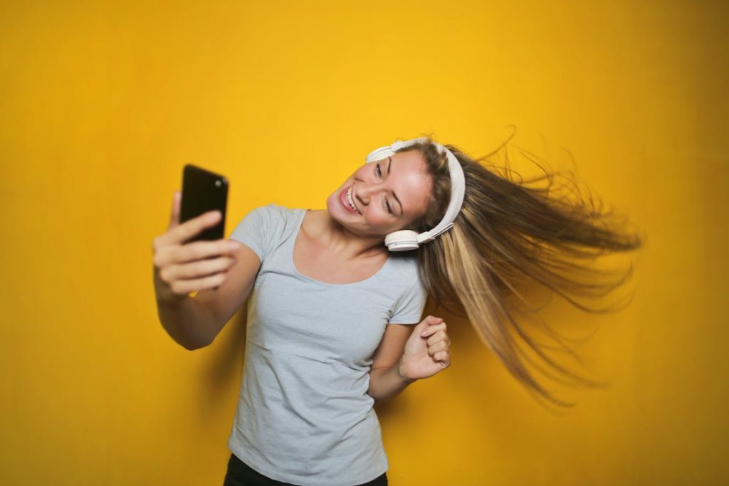 A very happy dancing lady after receiving ear wax removal by microsuction