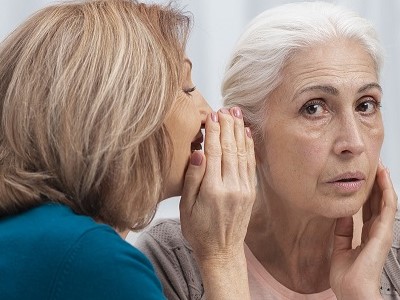 ladies-whispering-to-each-other-about-NovoearwaxClinic